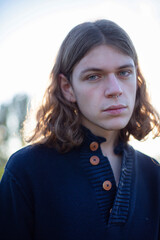 White european young man with long hair portrait