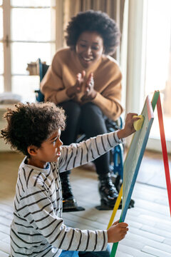 Happy Woman With Disability Learning Together With A Child. People Education Fun Concept