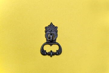 Furniture fittings, old vintage style drawer handle on yellow background