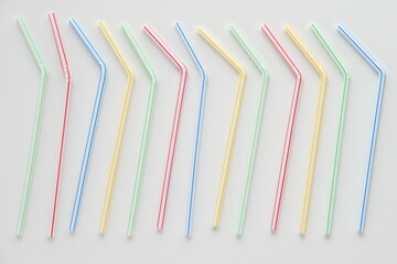 Disposable plastic straws on white background.