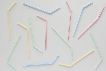 Disposable plastic straws on white background.