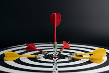 dart arrow hitting in the bullseye center of dartboard. concept of business targeting and aim for...