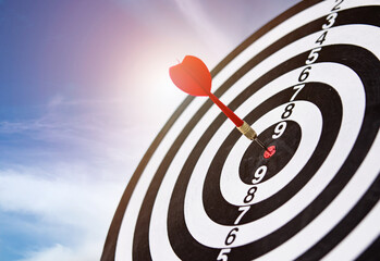 dart arrow hitting in the bullseye center of dartboard. concept of business targeting and aim for...