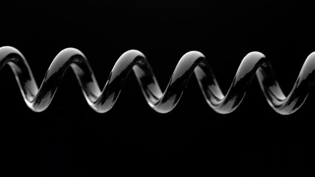 Spring is compressed and expanded against a black background.