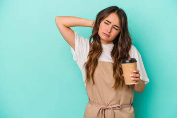 Fototapeta premium Young caucasian store clerk woman holding a takeaway coffee isolated on blue background touching back of head, thinking and making a choice.