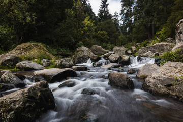 Naklejka na ściany i meble Small waterfall in the middle of the forest silk effect, Mexico, Magdalena Contreras