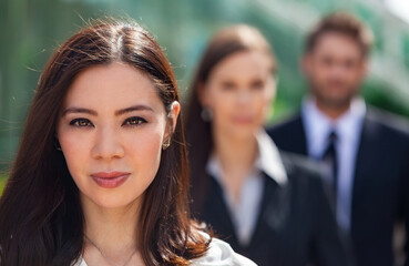 Asian Businesswoman in Mixed Race Male and Female Business Team
