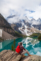 Hiking Man Looking at Moraine Lake and Rocky Mountains, Banff, Canada - obrazy, fototapety, plakaty