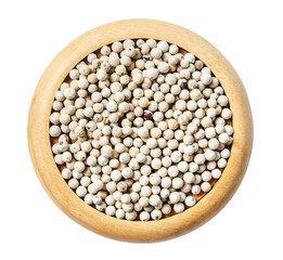 Dried white pepper seed in wooden dish isolated on white background.