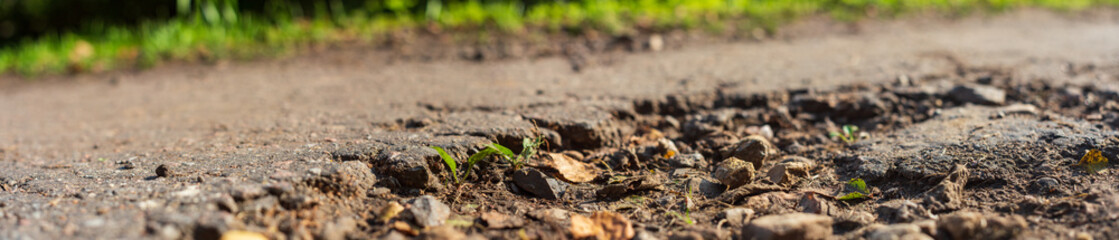 Panorama of a country road with a pit close up