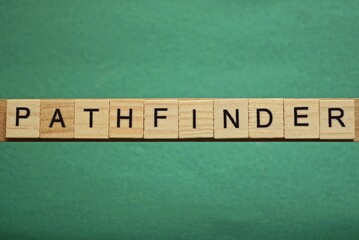 gray word pathfinder from small wooden letters on a green table