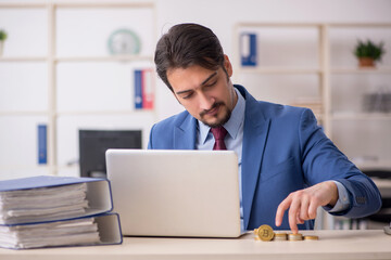 Young man earning money via Internet in cryptocurrency concept