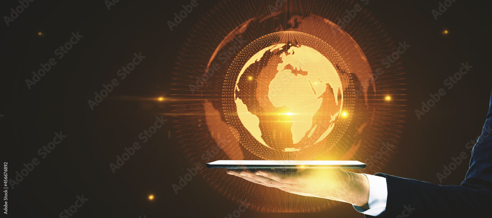 Poster Hand holding pad with glowing globe hologram on dark background with mockup place. Digital interface and global innovation.