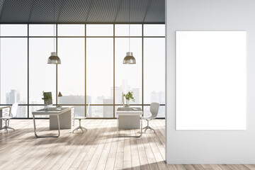 Modern coworking office interior with window and bright city view, desks, computer, monitors, chairs and wooden flooring with shadows. Empty mock up poster on wall. 3D Rendering.