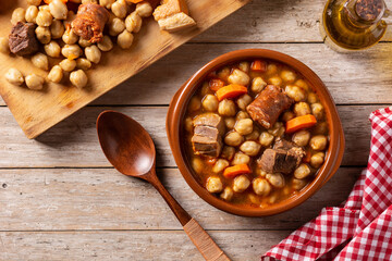 Traditional Spanish cocido madrileño on black background. Chickpea stew.