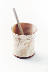 Traditional, handcrafted ceramic on bright wooden background. Soft focus. Close up. 