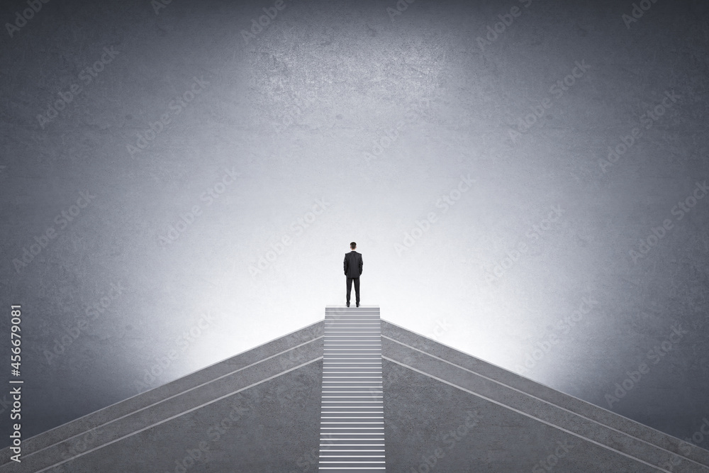 Poster back view of businessman on top of stairs with mock up place on concrete background. career growth a