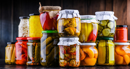 Jars with variety of marinated vegetables and fruits
