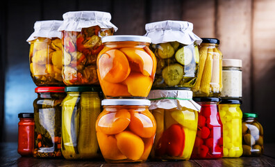 Jars with variety of marinated vegetables and fruits