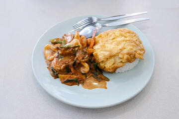 stir fried shrimp and squid with thai chili paste eat with steamed rice and omelet