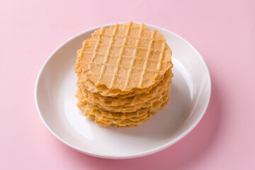 A stack of thin salty waffles on a plate