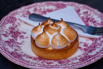 Delicious and fluffy French lemon tart dessert with whipped meringue cream