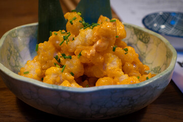 Popcorn shrimp is an appetizer made of tender shrimp that's coated in a seasoned breading, then fried until golden and crispy. 