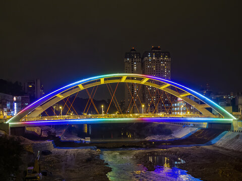 View of a beautiful arch bridge in the city with lights in Taiwan