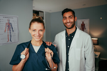 Caucasian female nurse standing with mixed race male surgeon