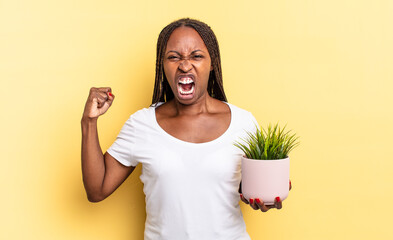 shouting aggressively with an angry expression or with fists clenched celebrating success holding a...