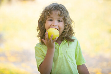 Child kid eating apple fruit outdoor autumn fall nature healthy outdoors.