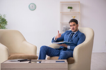 Young male employee waiting for business meeting