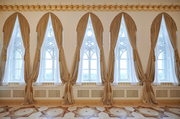 Tall windows with golden curtains