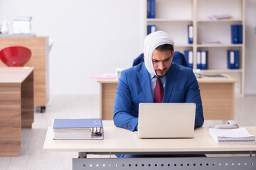 Young male employee suffering from toothache at workplace