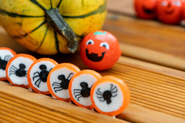 Halloween decorations background with pumpkins and sweets candies on the home wooden terrace