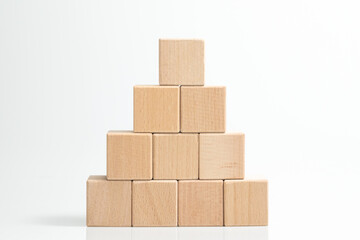Pyramid of ten wooden cubes, on white background