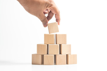 Pyramid of ten wooden cubes, isolated on white background