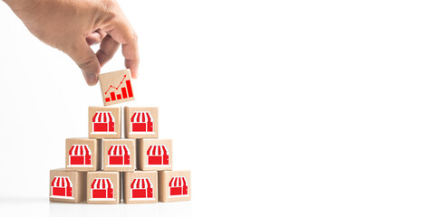 Business sale growth and expand shop franchise concept, Hand putting wood cube block which print...