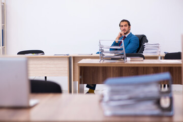 Young male employee working at workplace