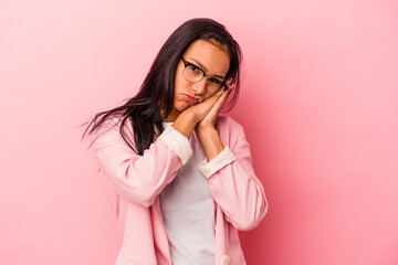 Young latin woman isolated on pink background  yawning showing a tired gesture covering mouth with hand.