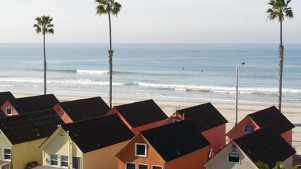 Colorful waterfront cottages in Oceanside, California USA. Multicolor bungalow huts by sea,...