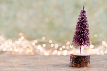 Colorful Christmas tree on green, bokeh background.