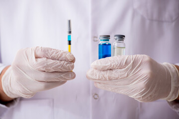 Young male doctor in vaccination concept