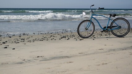 Blue bicycle, cruiser bike by ocean beach pacific coast, Oceanside California USA. Summertime...