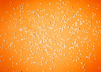 Organic oat flakes scattered over colorful background. Macro photo of natural raw food ingredient for healthy vegan and vegetarian diet. Flat lay composition of still life design.