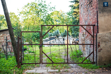 Metal gates with tied wooden branches.