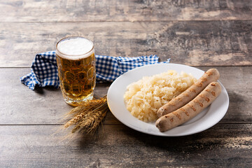 Bratwurst sausage ,sauerkraut, pretzels and beer on wooden table. typical german food	