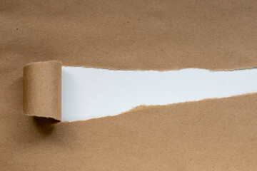 torn brown paper with white background. message space