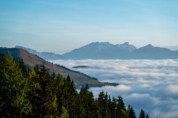 wonderful view in the morning with fog in the valley and blue sky on the mountains