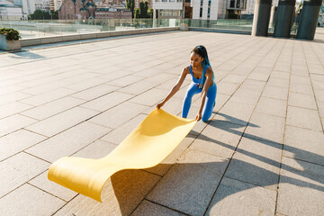 Smiling young african woman exercising © Drobot Dean